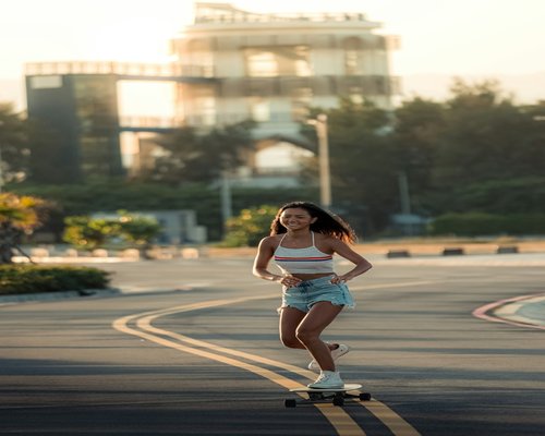 Happy woman jogging in a park morning sunlight