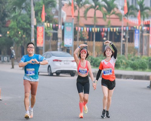 Group of friends running marathon together happiness
